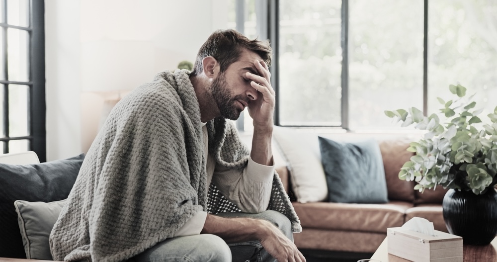 Adult male struggling with withdrawal symptoms while detoxing at home