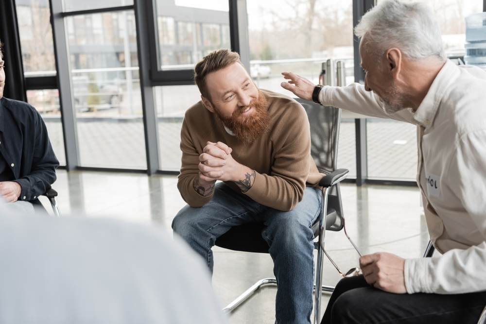 Man attending group meetings for recovery for ongoing addiction treatment