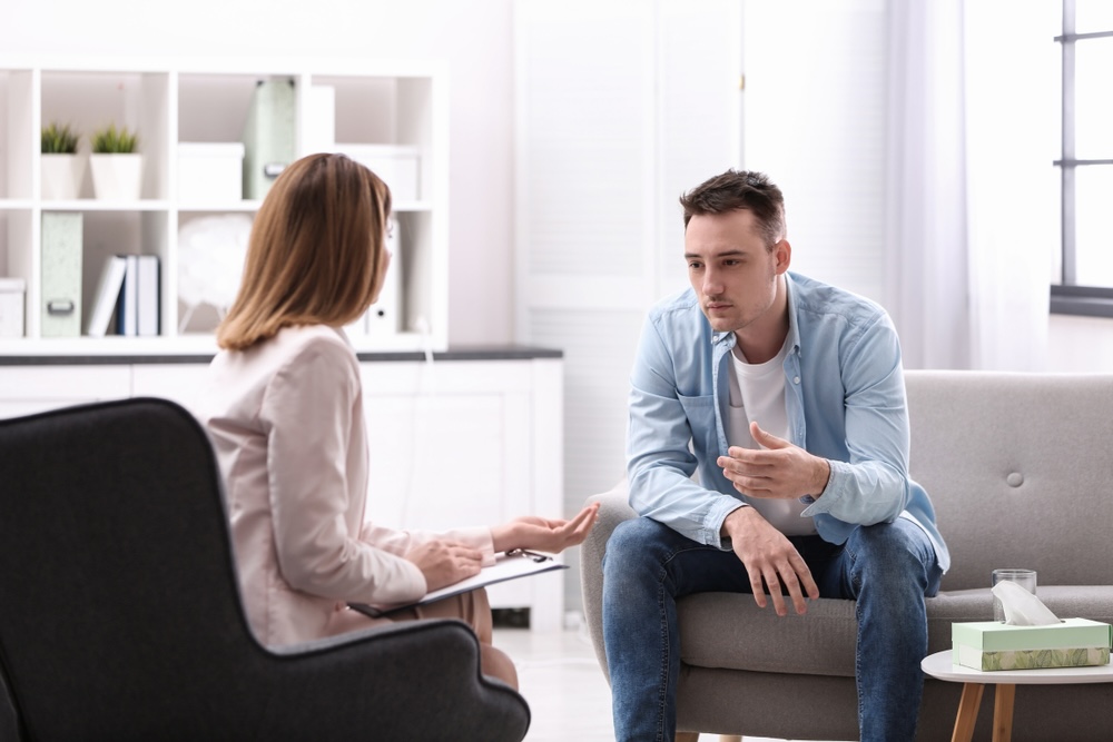 Adult male in rehab for meth addiction talking to an addiction specialist in Sonoma County CA